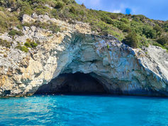 Paxos Blue Caves with turquoise water and white limestone cliffs in Ionian Sea Greece