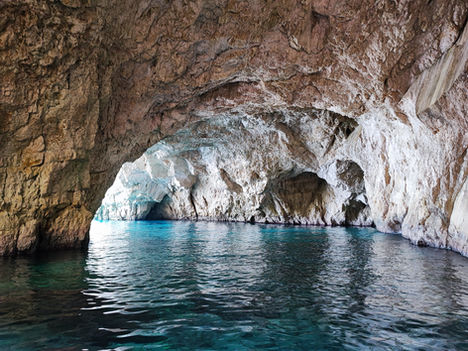 Crystal clear turquoise water inside the Blue Caves of Paxos, Ionian Islands.