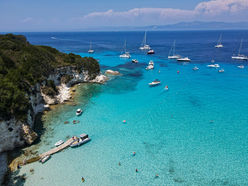 White sand beach Antipaxos with turquoise water accessible by private sailing boat Greece