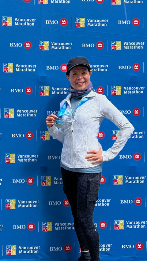 A runner with a finisher's medal after the Vancouver Half Marathon