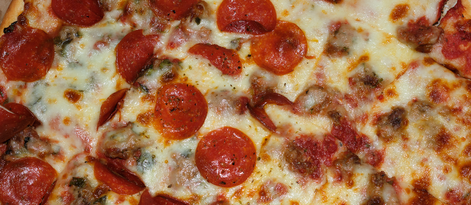 Paisans pizza with sausage, pepperoni and basil