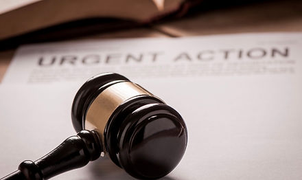 Judge's gavel resting on an urgent action legal document