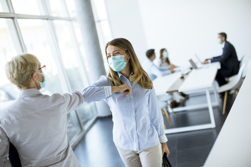 Business partners making social distanced greeting