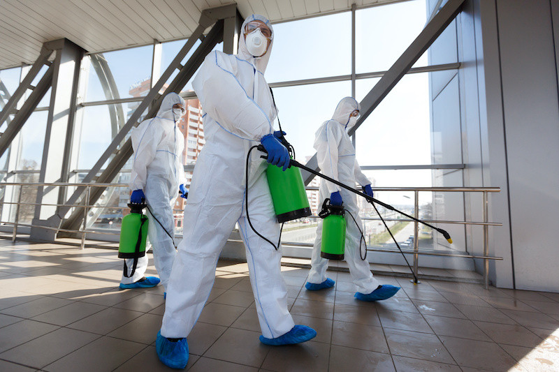 Specialist cleaners preparing to decontaminate an office building