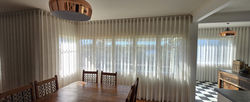 Sheer curtains across a wide window