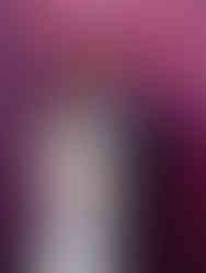 Nancy and Ammar share an intimate moment in front of a vivid pink and purple mural, smiling at each other as they embrace.