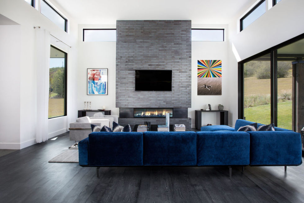Modern living room with fireplace and blue sectional sofa