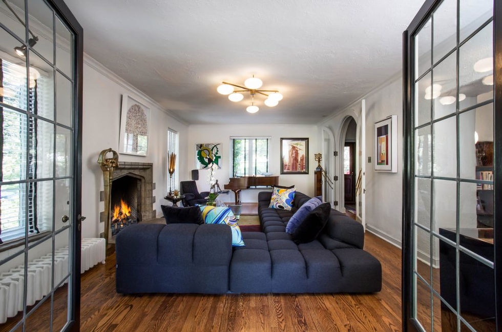 Spacious living room with sectional sofa, fireplace, and artwork