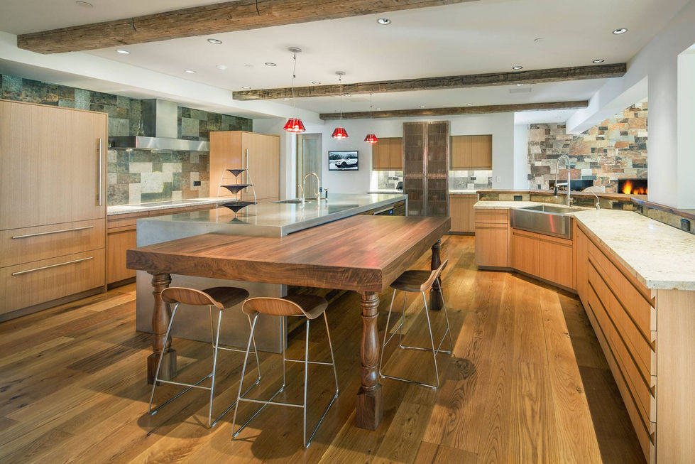 Large rustic kitchen island with wooden table and metal stools