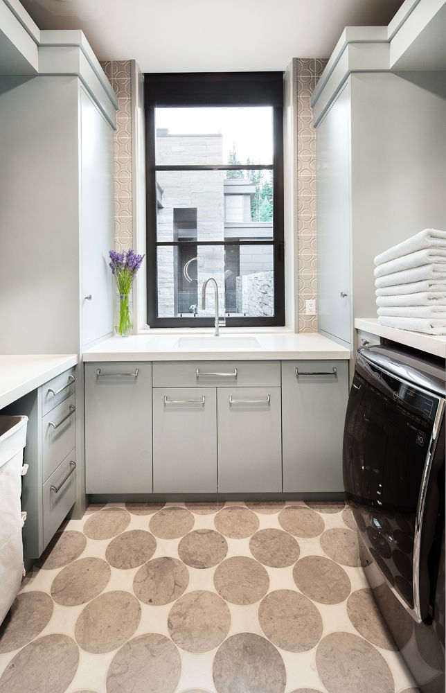 Modern laundry room with light cabinets and patterned floor