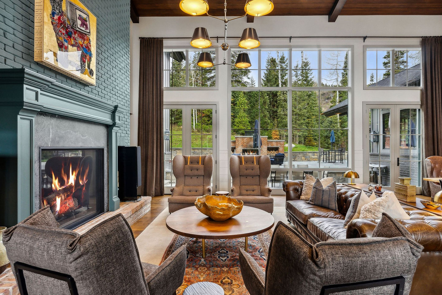 Modern living room with fireplace, and forest view