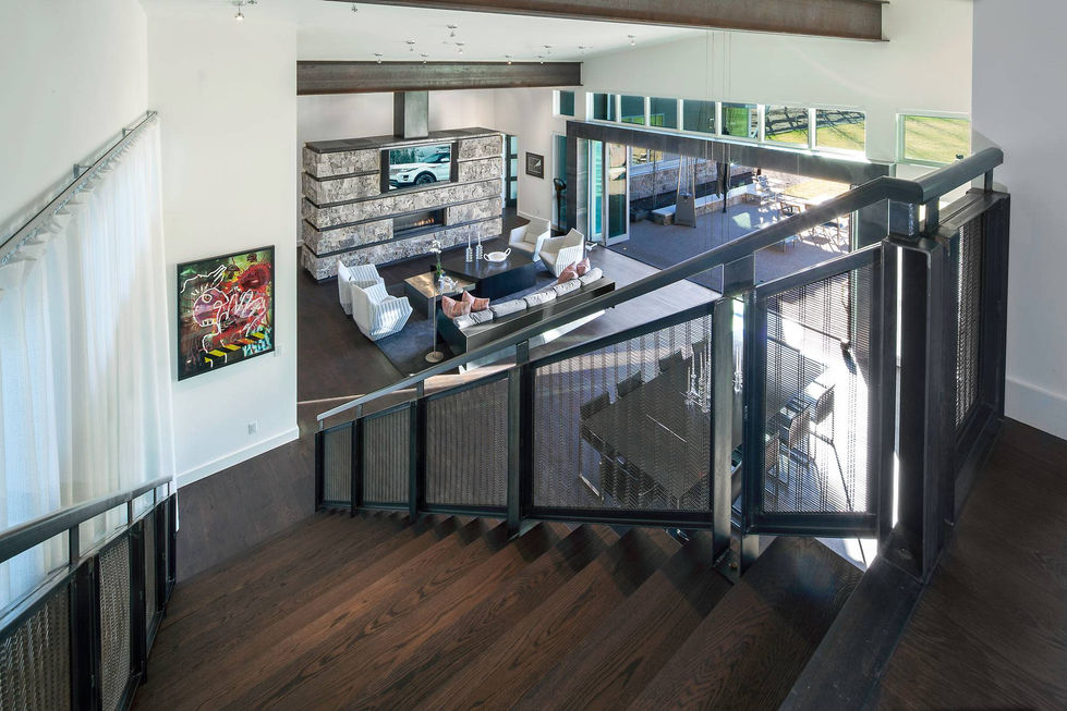 Modern home interior, open floor plan, dark wood stairs