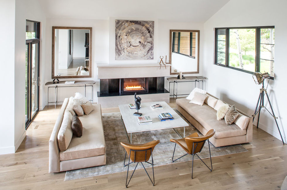 Modern living room with fireplace, sofas, and artwork