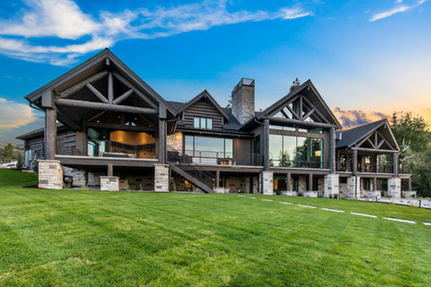 Luxury log home, expansive windows, grassy lawn