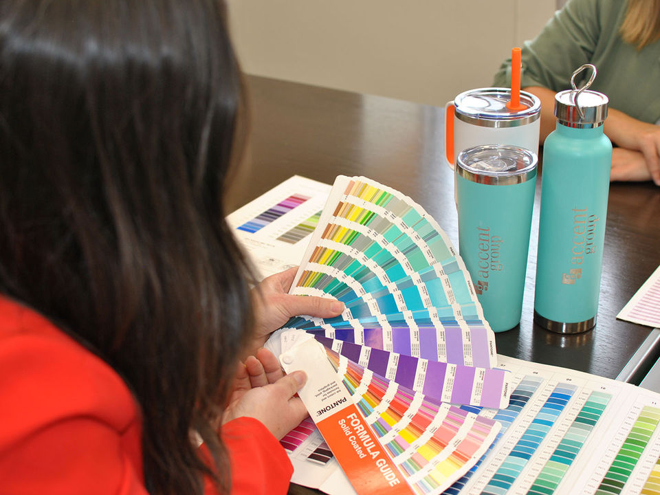 Person looking over a fan of colour swatches