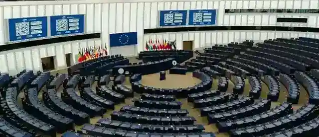 A semicircular parliament chamber with national flags