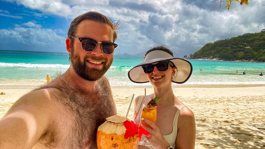 Two people with tropical drinks in the Seychelles