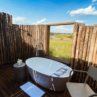Outdoor soaking tub at Singita Mara River Tented Camp