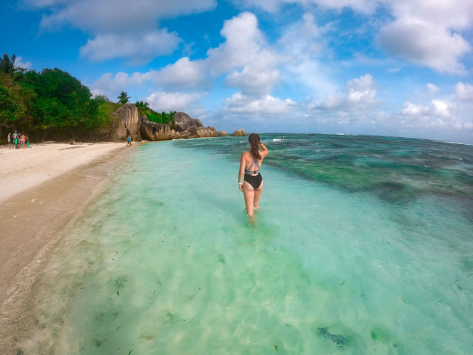 Woman walking in water at Anse Source d'Argent at La Digue in the Seychelles