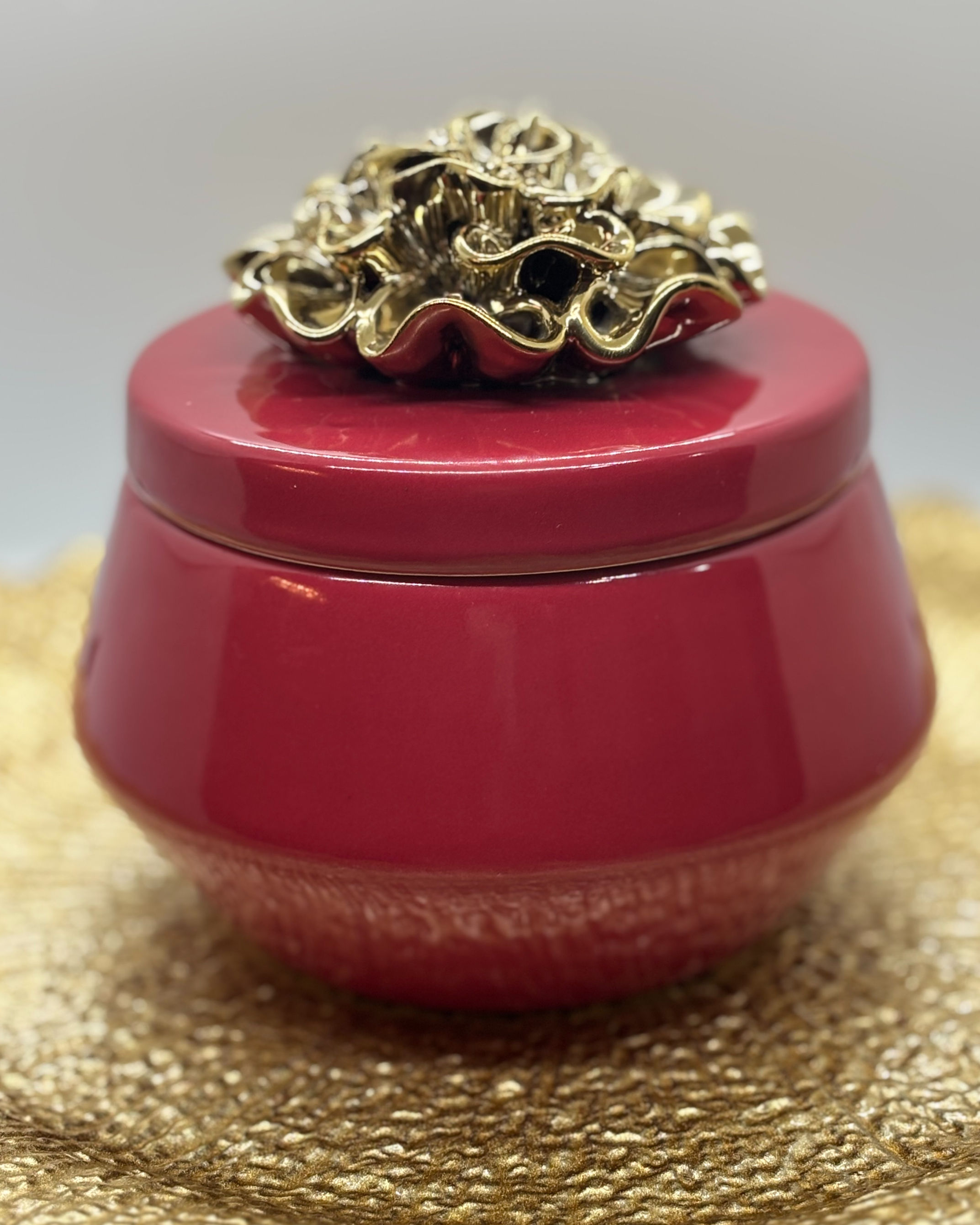 a candle in a red jar