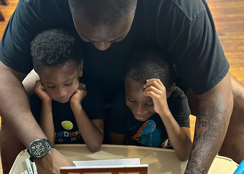 Boy with father reading creole