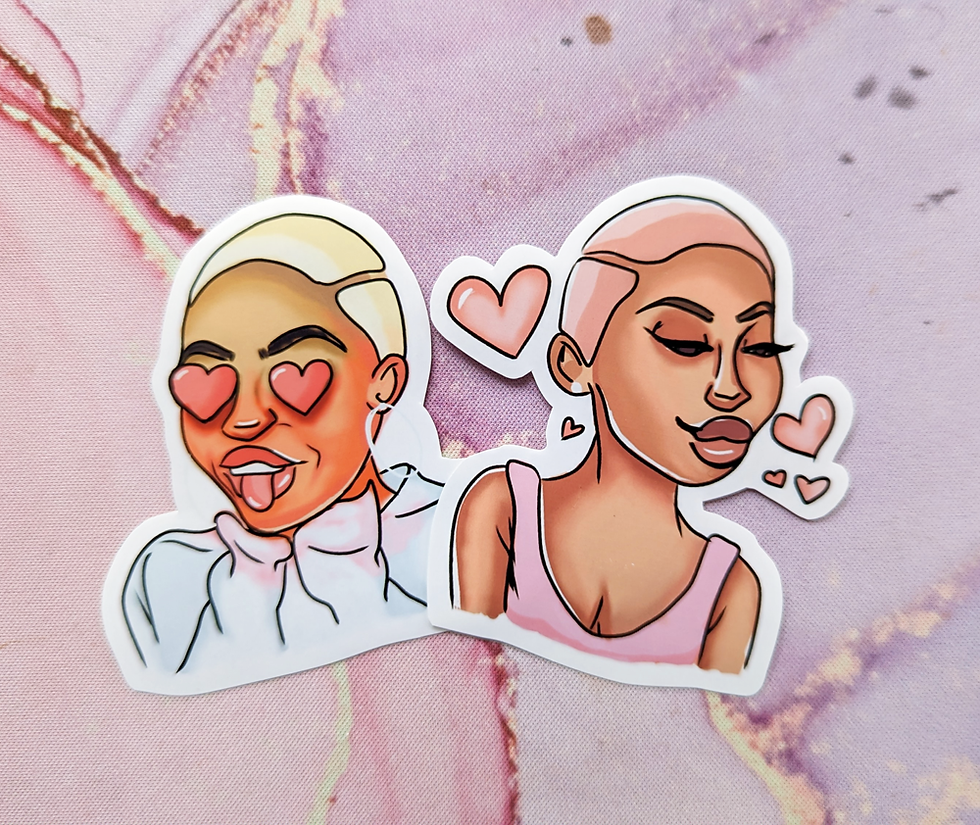 two glossy vinyl stickers of women with heart eyes and blowing kisses, resting on a table