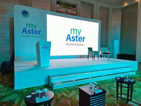 Formal conference setup with podium and seating arranged in a hotel ballroom.