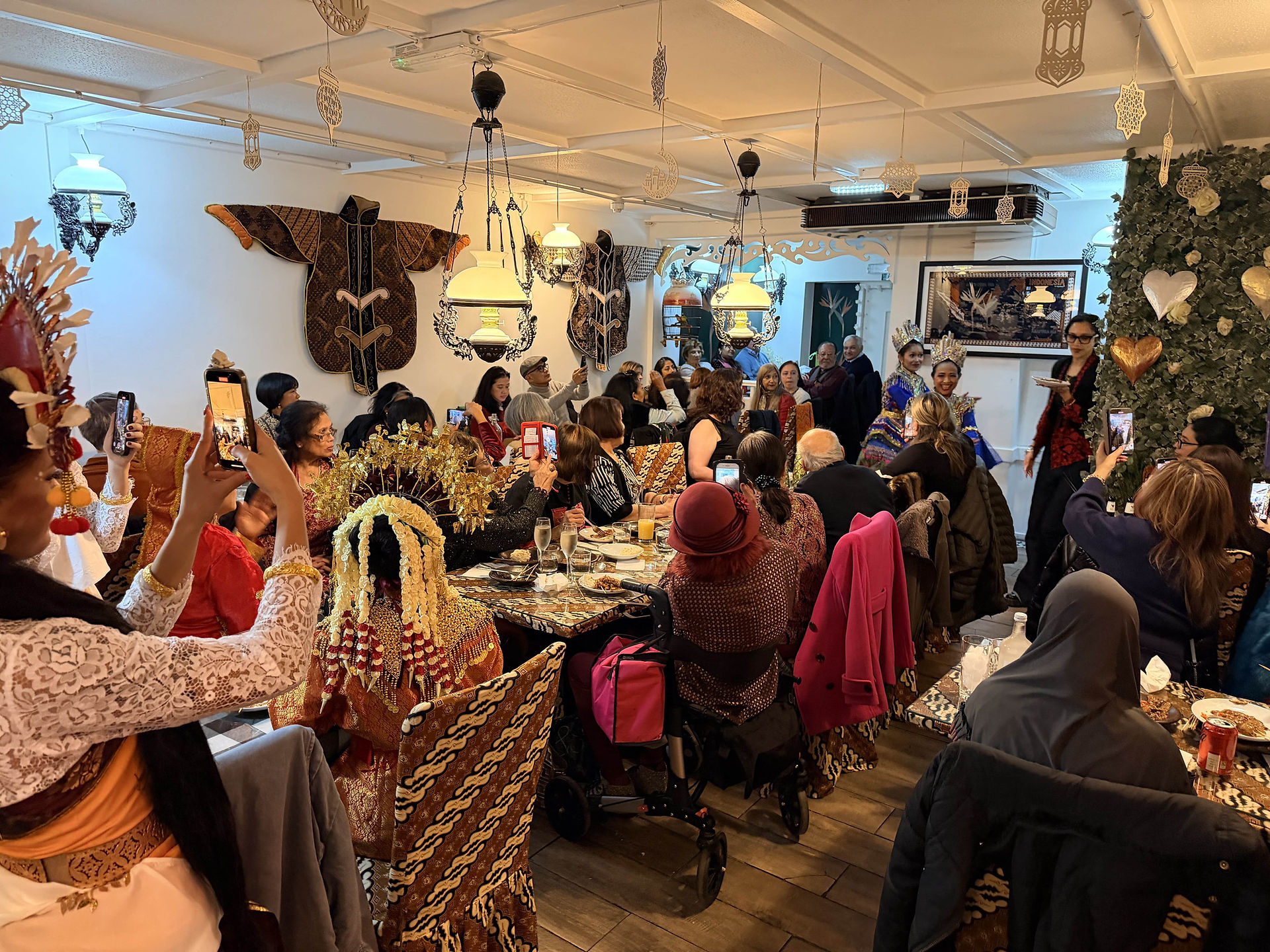 Interior of Bali Satay House during a special event night, with a full dining room and traditional Indonesian dancers performing.