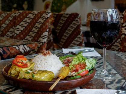 Nasi Campur Bali served with steamed rice, grilled and slow-cooked Indonesian dishes, sambal, and fresh elements at a family-run Indonesian restaurant in Barnet, London.