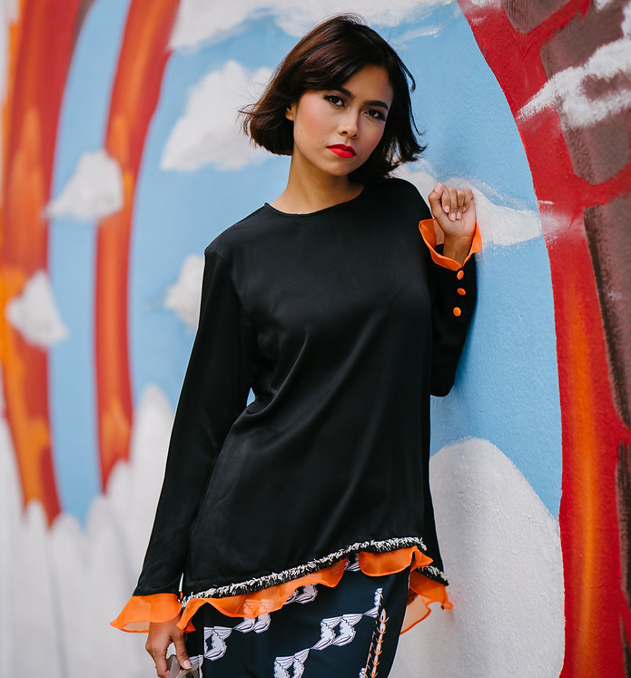 woman-wearing-black-long-sleeved-shirt-learning-on-wall-1115972.jpg
