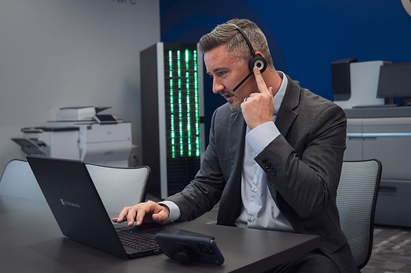 Professional using business phone systems with a headset.