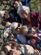 Women exploring Amble Harbour, Northumberland seaside town, scenic coastal walk, independent shops and waterfront views in “The Friendliest Port