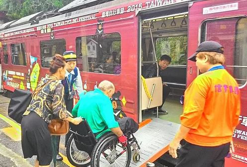 TRA train staffs help to arrange the ramp for wheelchair users getting on/off the train.