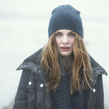 a woman wearing a beanie and winter coat