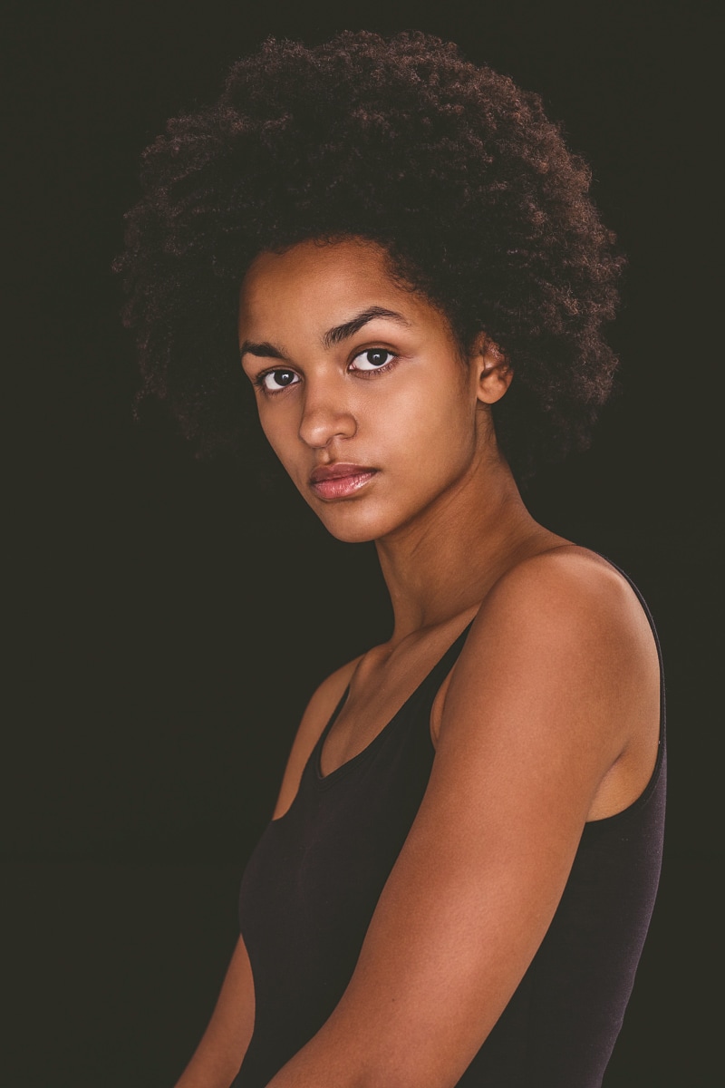 Portrait of a Thoughtful Woman Posed Against a Dark Background