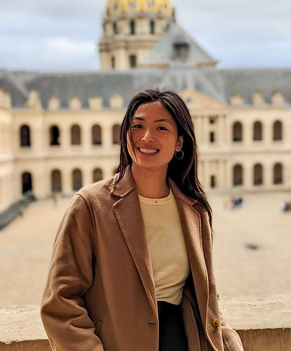 A woman standing in front of a building in Europe.