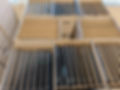 Rows of laptops packaged vertically in cardboard boxes for shipping.