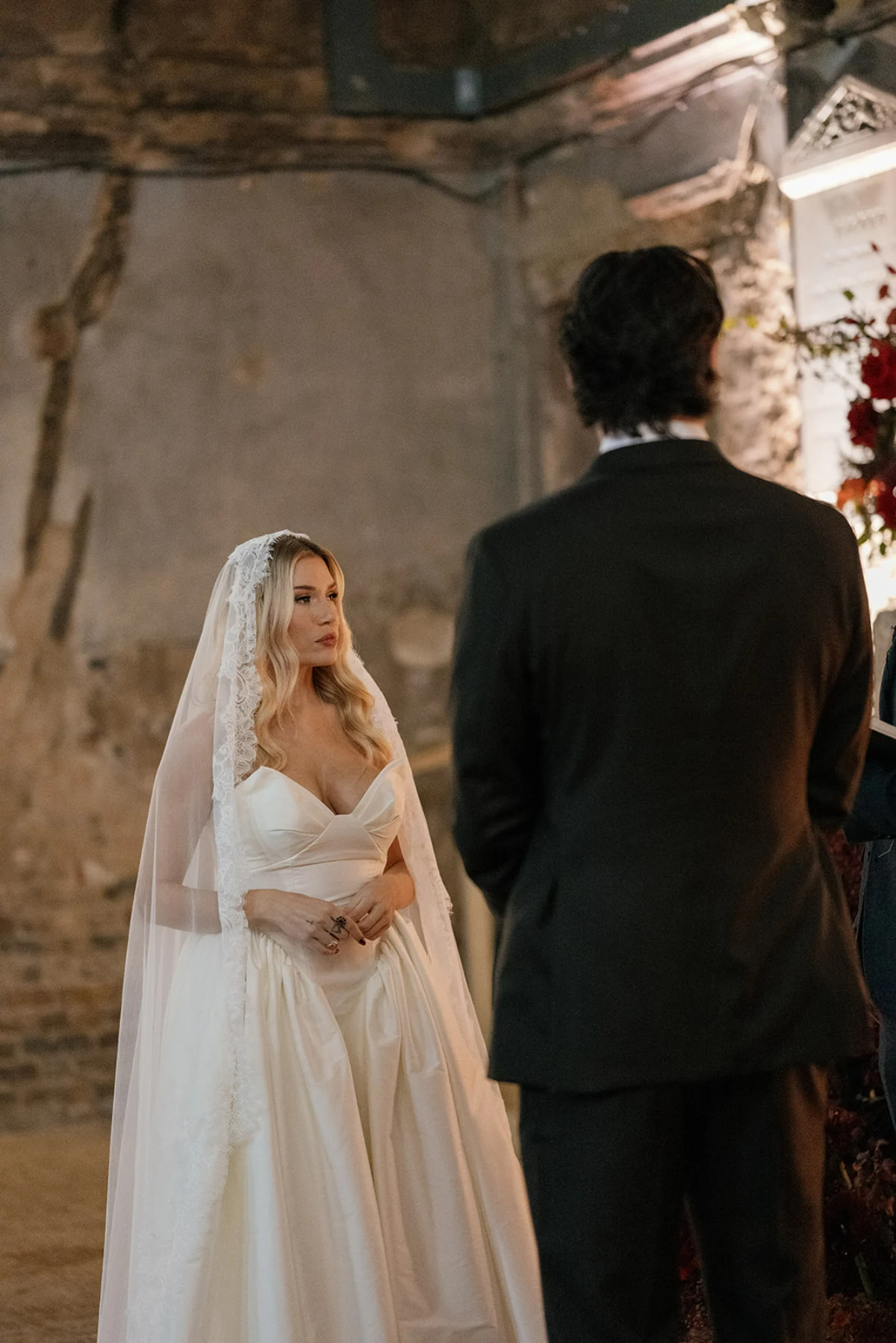 A couple stand in front of their officiant in Asylum Chapel on their wedding day.