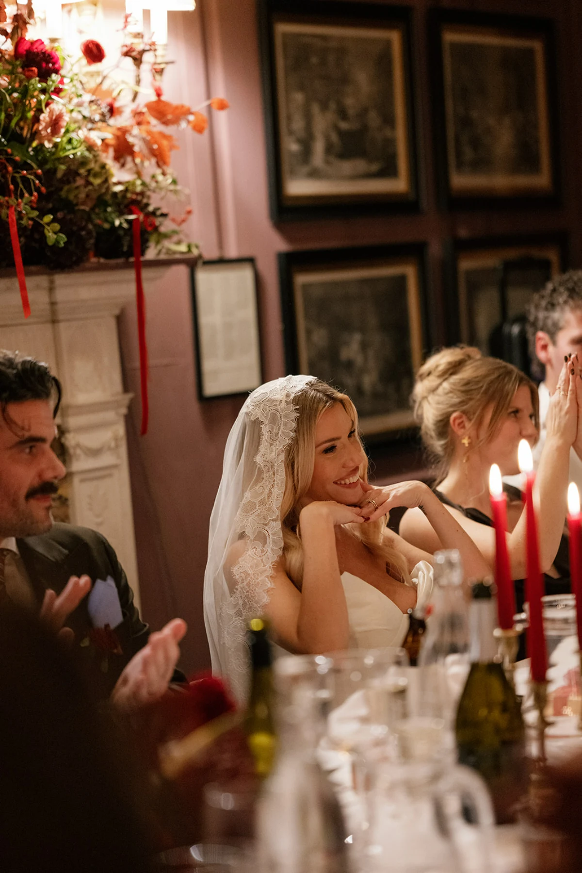 A bride smiles while enjoying a wedding breakfast with guests at Brunswick House, London.
