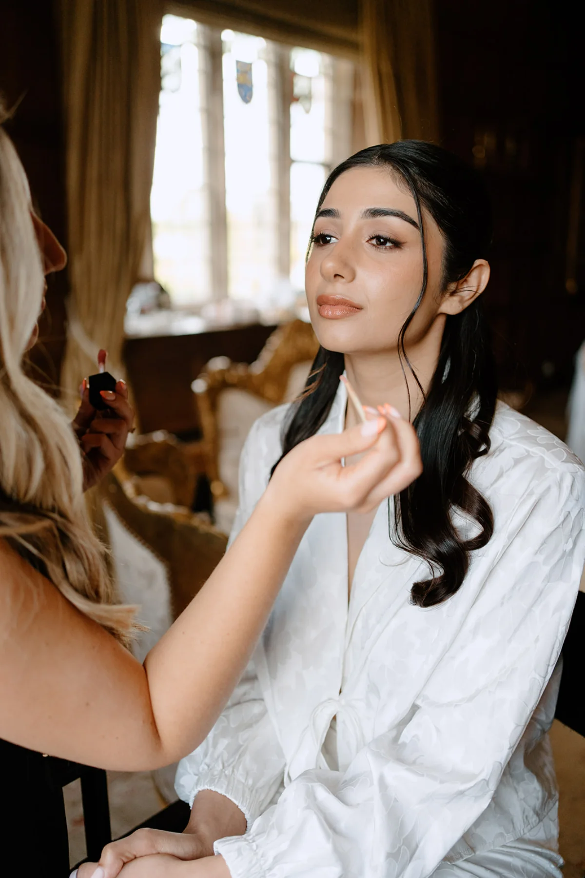 Suffolk bridal makeup artist Emily Chantal preps a bride on her wedding day.