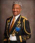 Smiling man wearing crown and holding a sceptor