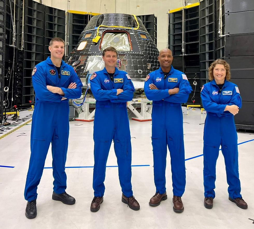 Artemis 2 crew standing in front of Orion Crew Module surrounded by MSI DFAT acoustic test system. Left to Right: Jeremy Hansen, Reid Wiseman, Victor Glover, Christina Koch. Credit: NASA/Lockheed Martin.