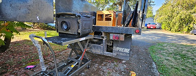 Rear of a Supreme work truck with equipment on a hydraulic lift