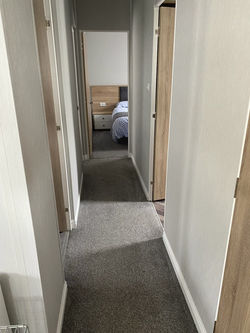 Main hallway to Utility and then bathroom and 3 bedrooms