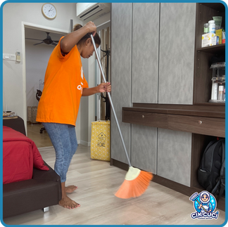 Maid service in Malaysia cleaning a modern living room