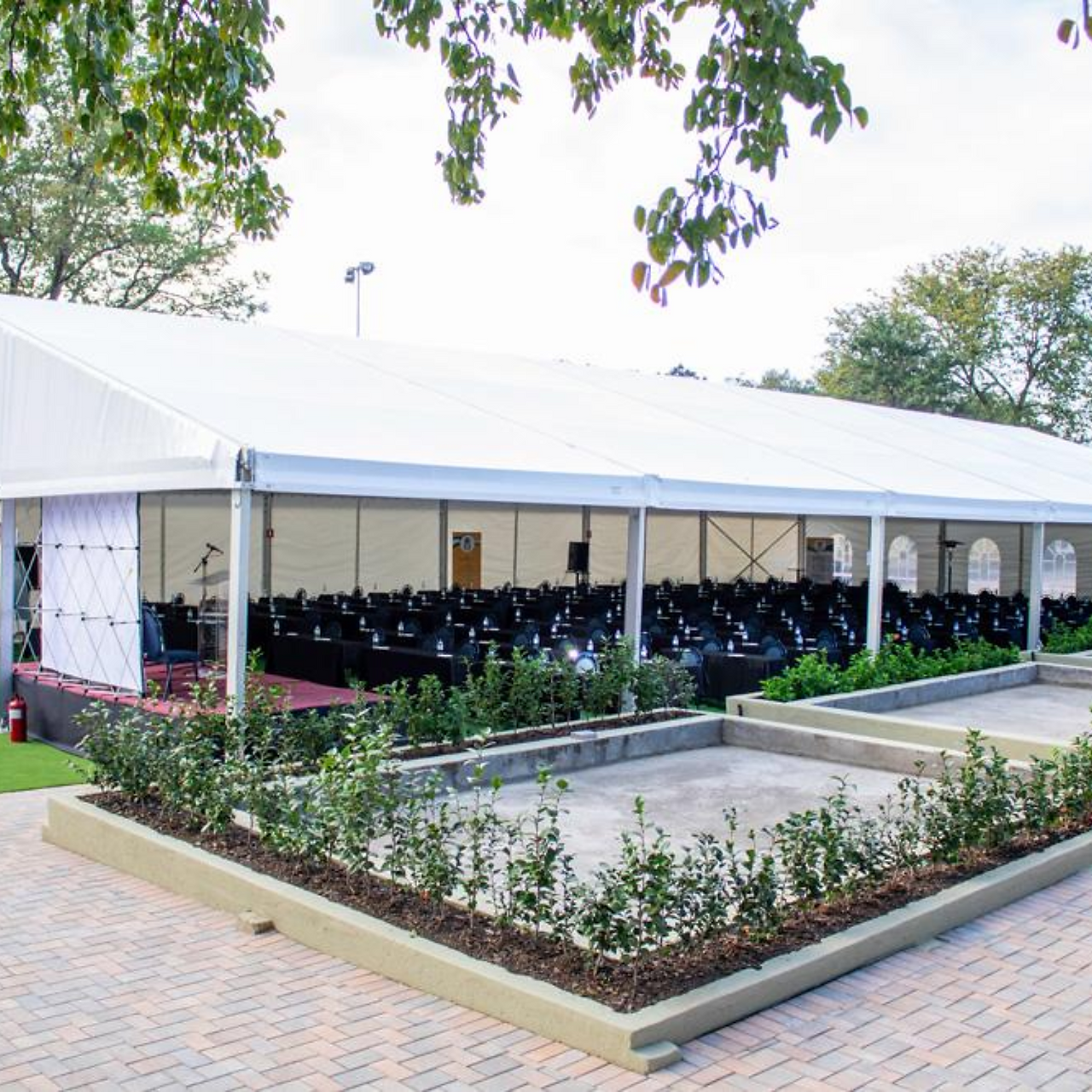 Event tent installed in a parking area for an exhibition or corporate activity.