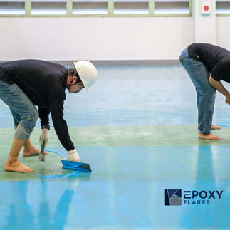 White epoxy flake floor coating installed in a bright Malaysian bathroom.