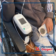 Medical staff installing portable oxygen for travel into patient’s car
