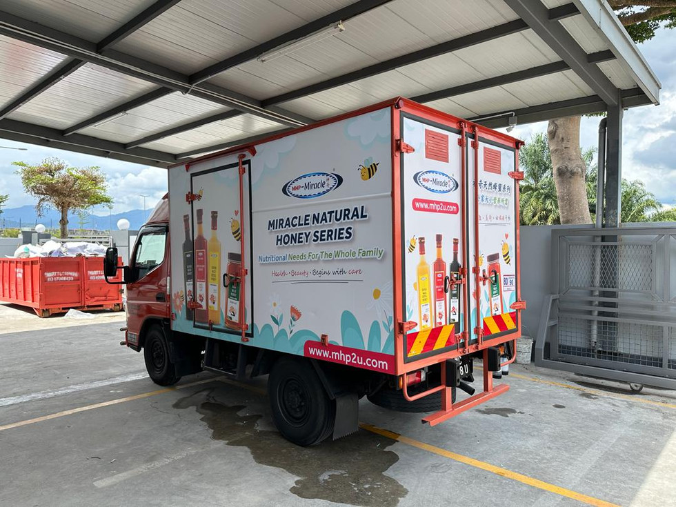 Proses akhir pemasangan sticker lori dilakukan oleh pasukan teknikal