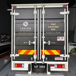 Lorry driving safely at night in Selangor with high-visibility stickers